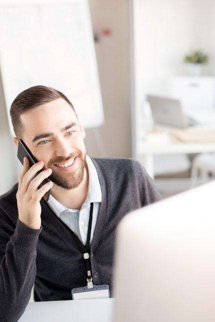 Smiling Office Worker Speaking by Phone